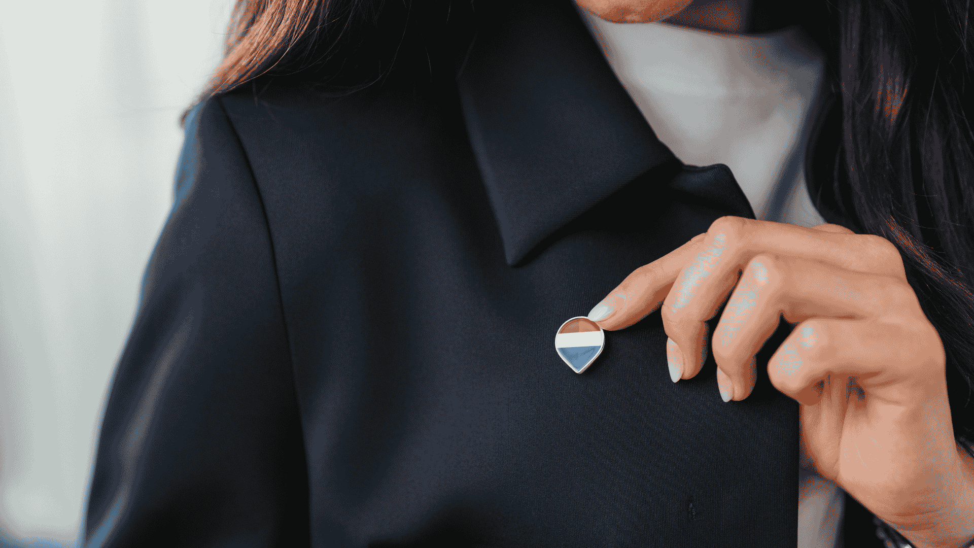 REMAX balloon pin on black blazer.